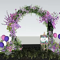Floral Event Entrance Arch With Pink Purple Flowers Balloons Easel Sign And Green Grass