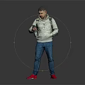 A man wearing hoodie and jeans using phone with backpack on gray background