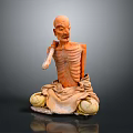 Emaciated Man Statue Sitting on Ground with Tattered Clothes and Wooden Cane Against Gray Background