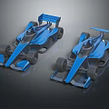 Two Blue Streamlined Formula Racing Cars With Aerodynamic Body And Rear Wings