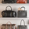 Stylish Assorted Handbags in Various Colors Displayed on White Shelves
