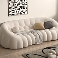Beige Curved Double Sofa With Petal Shaped Design Cushions Throw Blanket And Geometric Wall Art