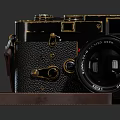 Vintage Digital Camera With Leather Strap Black Body And Gold Accents Lens