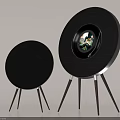 Two Black Round Speakers With Tripod Stands And Display Screen