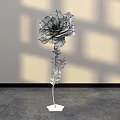 Large Paper Flower Floral Installation With Orange Yellow Petals Green Stem And Shadowy White Wall