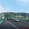 Outdoor Lights Along Highway With Street Lamps Green Mountains And Cars Driving