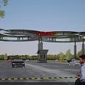Modern Entrance Gate Structure With LOGO On Top And Cars In Parking Area