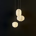 Three Modern Lantern Shaped Fabric Pendant Lights With Soft Lighting On Dark Background 3d model