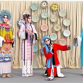 Group of Chinese Opera Performers in Traditional Costumes with Decorative Plates Backdrop