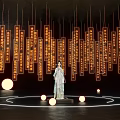 Woman in Traditional Costume Standing With Hanging Inscribed Plaques Circular Light Rings And Glowing Orbs