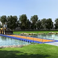 Orange Floating Bridge Over Water With Green Grass Trees And Bulldozer Nearby