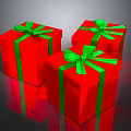 Three Red Gift Boxes With Green Bows On Shiny Reflective Surface