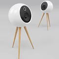 Two White Ball Shaped Speakers with Black Speaker Units on Wooden Tripods