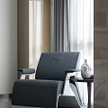 Modern Gray Single Sofa With Fabric Upholstery And Side Table Vase In Natural Light Room