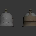 Two Antique Metal Helmets With Decorative Tops And Riveted Edges On Shiny Surface