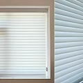 White Window Blinds With Horizontal Slats On Window And Building Exterior
