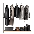 Stylish Coats And Jackets Hanging On Black Rack With Leather Bags And Boxes