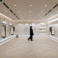 Fashion Clothing Store Interior Featuring Bright Lighting Herringbone Floor Displayed Clothes And Person Walking