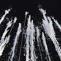 Garden Ornament With Vertical Water Jets As Decorative Water Feature On Black Background