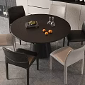 Modern Dining Table Set Round Black Table With Black And Beige Chairs Oranges Glass Vases