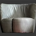 Modern Single Sofa With Curved Back Round Ottoman And Plush Upholstery