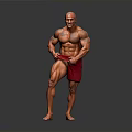 Muscular Man Posing to Showcase Well Developed Muscles in Red Shorts