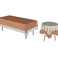 Long Rectangular and Round Dining Tables with Orange and White Ruffled Edge Tablecloths