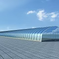 Modern Industrial Factory Building With Glass Arched Roof And Spacious Ground Under Clear Blue Sky