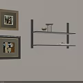 Light Wall Corner With Framed Abstract Paintings And Black Shelf Holding White Vase And Books