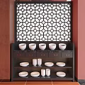 Dark Wood Sideboard With White Bowls Plates And Drawers Against Red Wall Geometric Lattice Screen