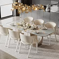 Elegant Restaurant Dining Space With Round Table White Chairs Golden Chandelier And Floral Decor
