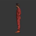 Man in Red Jumpsuit and Orange Shoes Standing Against Grey Background