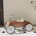 Stylish Brown Children's Toy Car With White Seat And Silver Steering Wheel On Checkered Rug