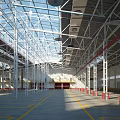 Spacious Industrial Warehouse Interior With Steel Structure Glass Roof High Ceiling And Red Barriers
