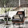 Elegant Black Leather Armchair With Gray Pillow And Small Round Table In Modern Interior