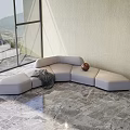 Light Gray Irregular Shaped Sofa With Blanket And Decorative Ball In Modern Living Room