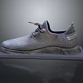 Gray Knit Sneakers With Lace Up Design And Textured Sole On Display Stand