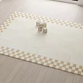 Stylish Square Carpet With Beige And Gold Checkerboard Border On Light Wooden Floor