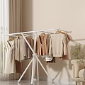 Living Room with White Clothes Rack Various Clothes Beige Sofa Curtains and Green Plant