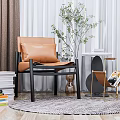 Modern Leisure Chair Featuring Brown Leather Cushion Black Frame And Indoor Plant With Woven Rug