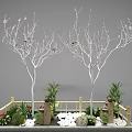 Garden Ornament With Two White Trees Pink Blossoms Green Plants Bamboo Fence And White Pebbles