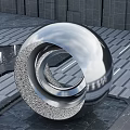 Modern Metallic Spherical Sculpture With Circular Ring Design On Stone Floor Against Gray Wall