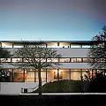 Modern Detached House Exterior Design With Large Glass Windows And Evening Lighting