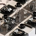 Elegant Black Dinnerware Set with Plates Bowls Cups Utensils Wine Glasses on Dining Table