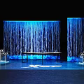 Modern Exhibition Scene With Blue Water Curtain Walls And Transparent Display Stands