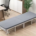 Gray Folding Bed With Wheels In Office Area Near Desk Chair And Plant