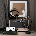 Stylish Over Ear Headphones With Gold Accents On Black Audio Speaker Near White Bust