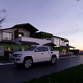 Modern Bed and Breakfast Building With Greenery Covered Balconies Outdoor Seating and Twilight Sky View