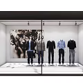 Fashion Store Window Display With Mannequins In Colored Tops And Black White Artwork