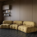 Yellow Velvet Sectional Sofa Against Wooden Wall With Black Tiled Floor And Shelf Decorations
